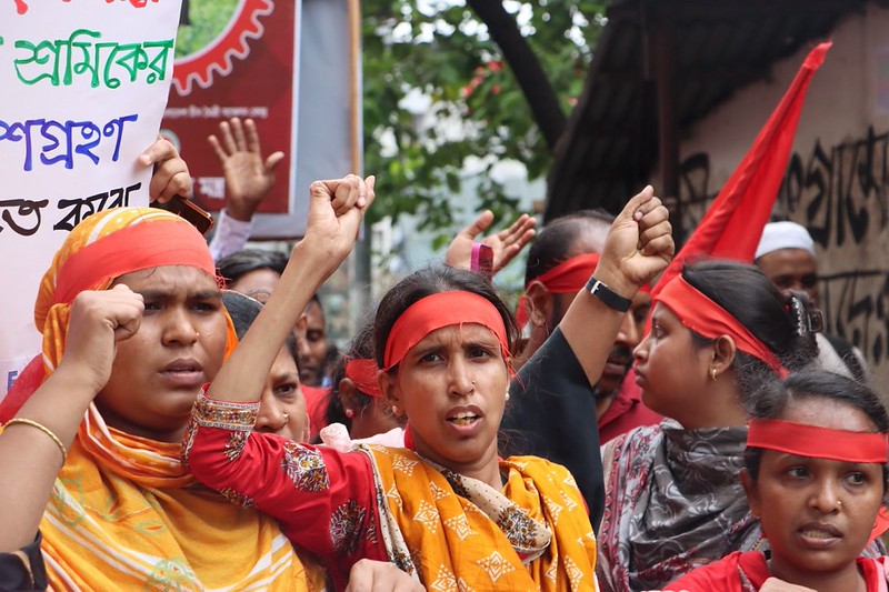 Women workers raise their fists at a May Day demonstration in Bangladesh