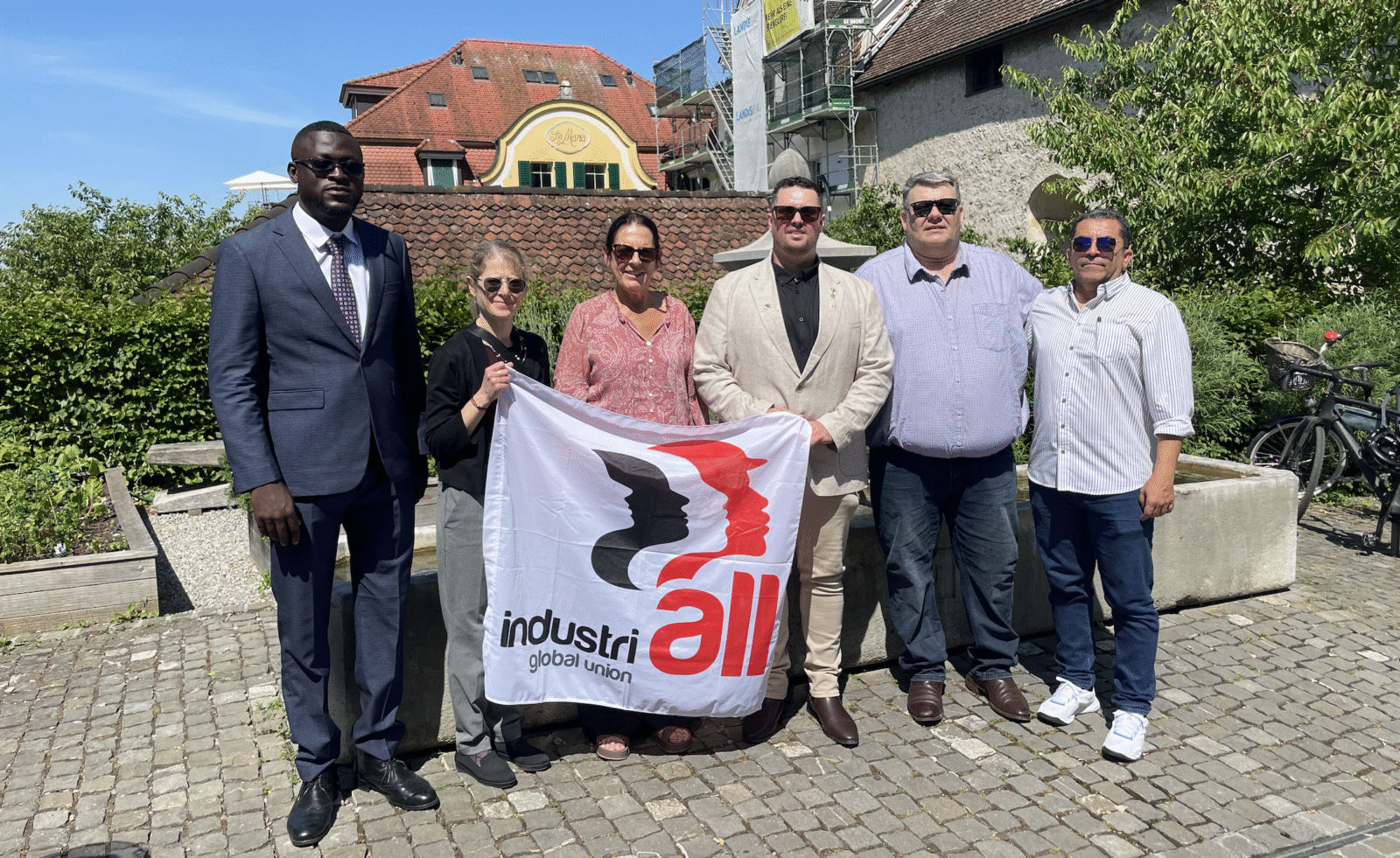  IndustriALL Global Union delegation holds an IndustriALL flag in Zug, Switzerland, ahead of the Glencore annual general meeting, 28 May 2026.
