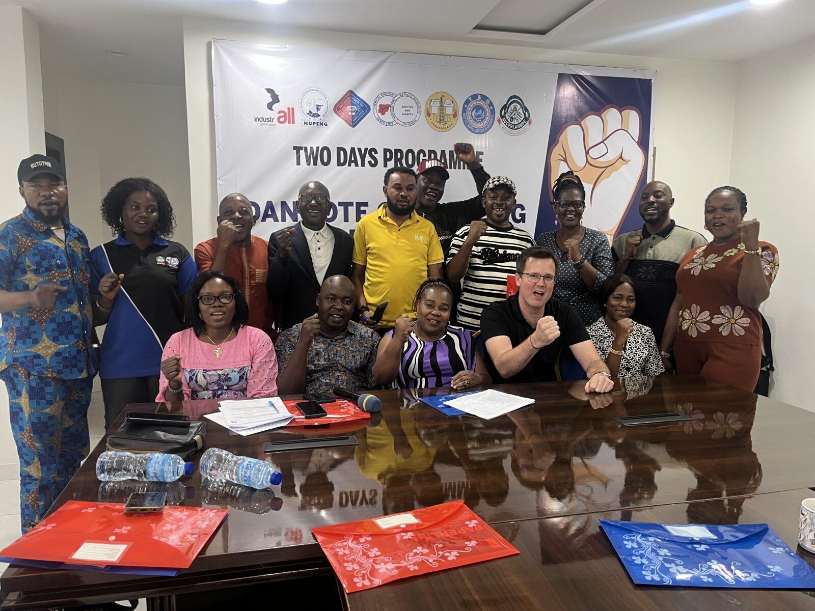 Trade union representatives raise their fists in solidarity at a two-day meeting on organising across the Dangote Group, Lagos, Nigeria.
