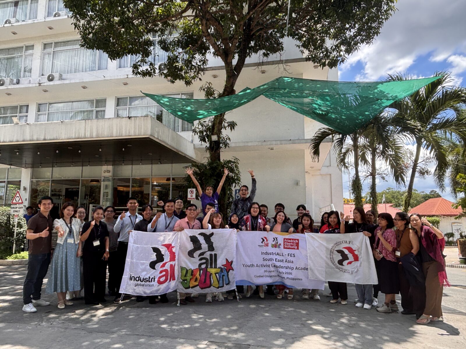 Group of young trade unionists pose with banners outside the IndustriALL-FES South East Asia Youth Activist Leadership Academy venue in the Philippines.