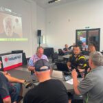 Delegates at the joint industriAll Europe and IndustriALL Global Union roundtable in Durham, with a participant joining remotely.