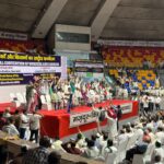 Leaders Raise Fists on Stage at Workers' and Farmers' Convention