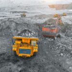 A haul truck is loaded with rock at an open-pit mine.