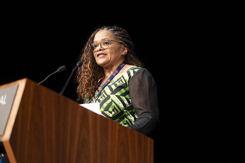 Christina Olivier, IndustriALL assistant general secretary, speaking at a podium