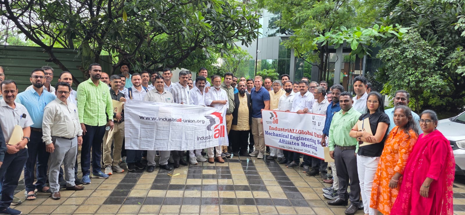 Trade union leaders from India's mechanical engineering sector gather outdoors holding IndustriALL banners at the strategic organizing workshop in Pune on 11-12 August 2026.