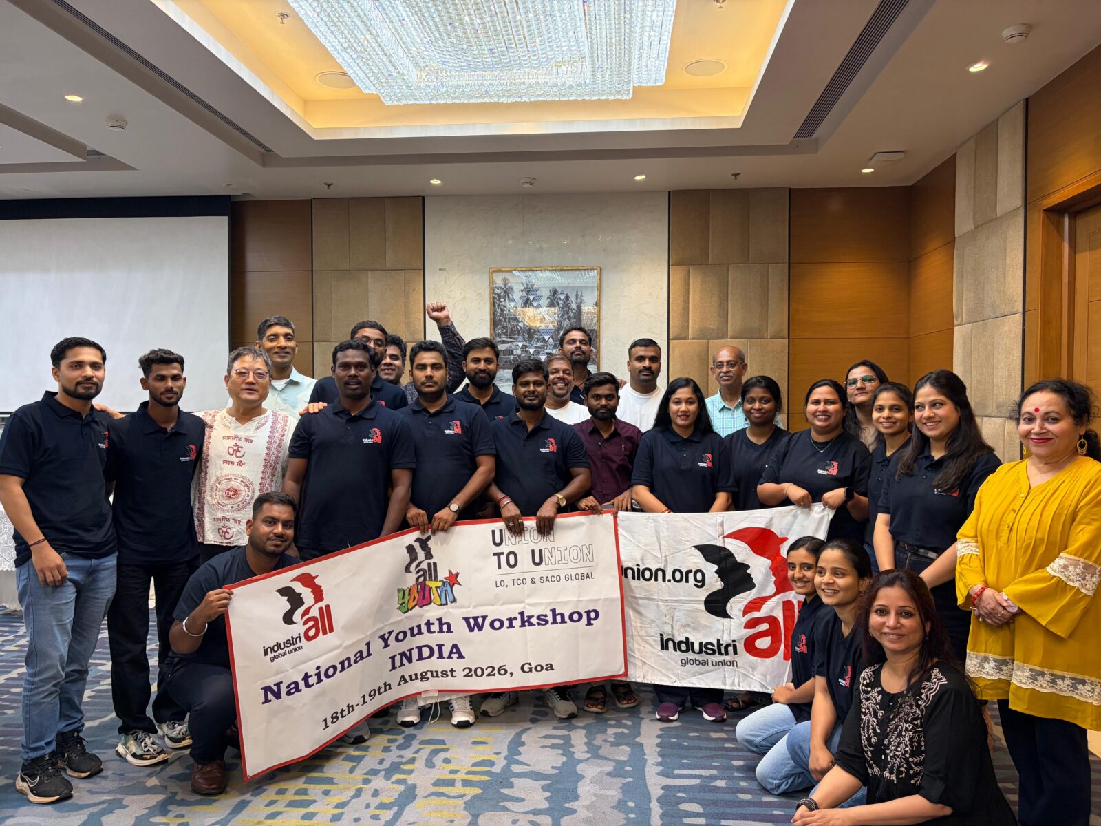 Group photo of approximately 30 young union activists and facilitators holding an IndustriALL banner reading "National Youth Workshop INDIA 18-19 August 2026, Goa".