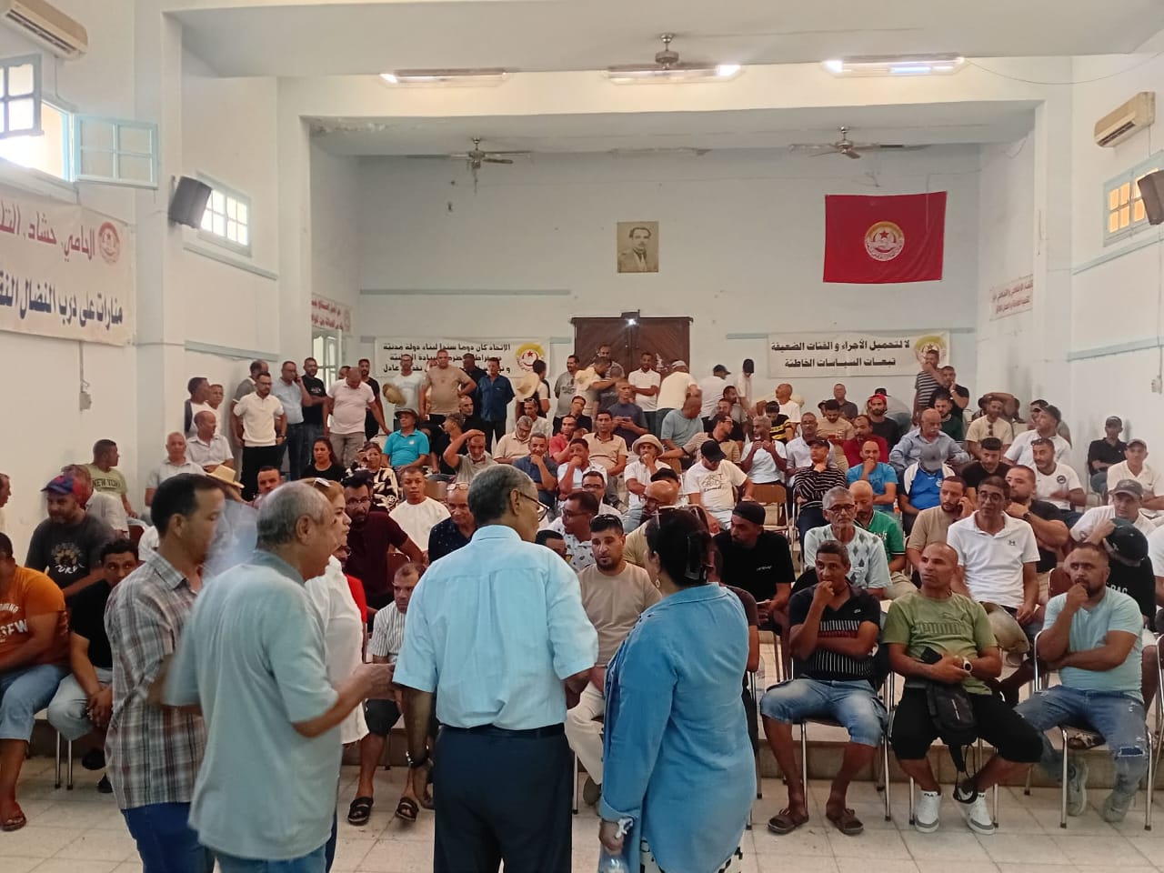A large indoor gathering of workers and union members at the Regional Labor Union headquarters in Gafsa, Tunisia.