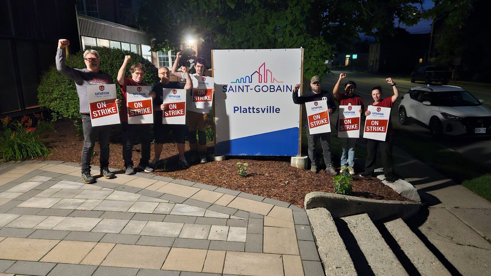 Unifor Local 12 members holding "On Strike" signs outside Saint-Gobain's Plattsville facility