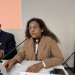 Sanjyot Vadhavkar, co-chair of the Base Metals sector, speaks into a microphone at the conference in Pragu