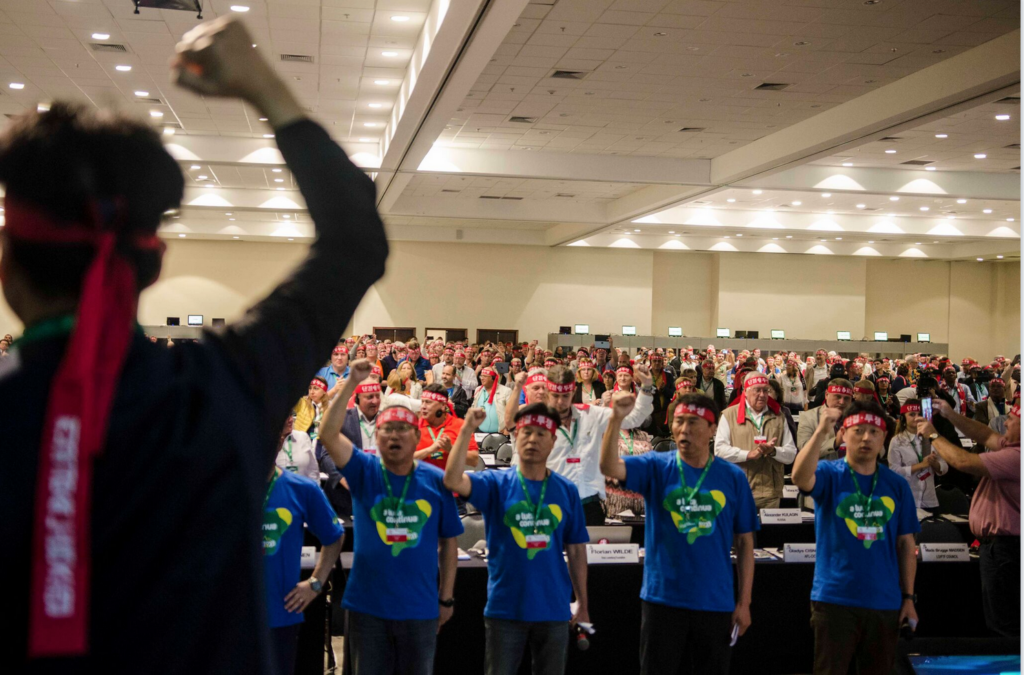 Congress delegates putting on red headbands in support of Korean trade unions, whose rights are under serious attacks.
