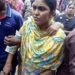 A worker at the Haesong factory is led away. 