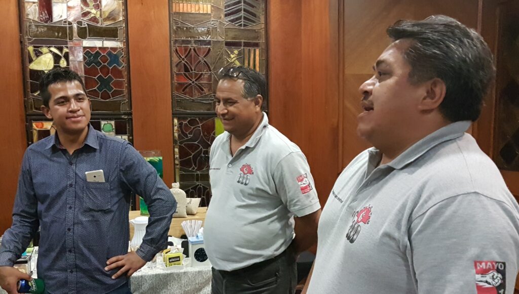 Trade union leaders from Continental discussing organizing with a worker from Goodyear. 