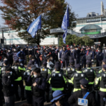 Densely packed police squads close in with shields up forcing rally participants into smaller spaces unable to socially distance. 