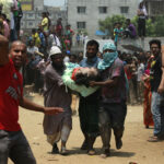 Credit: Andrew Biraj/ REUTERS Caption: People carry the body of a garment worker, who was working in the Rana Plaza building when it collapsed, in Savar, 30 km (19 miles) outside Dhaka April 24, 2013. The eight-storey block housing factories and a shopping centre collapsed on the outskirts of the Bangladeshi capital on Wednesday, killing more than 70 people and injuring hundreds, a government official said.