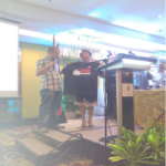 IndustriALL  project coordinator Ramon Certeza presenting the Stop Precarious Work T-Shirt to Rosalinda Baldoz, Secretary of the Department of Labour and Employment